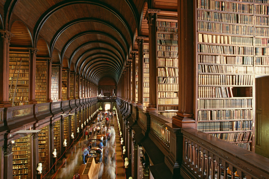 Interior of old wooden library filled with leather bound books